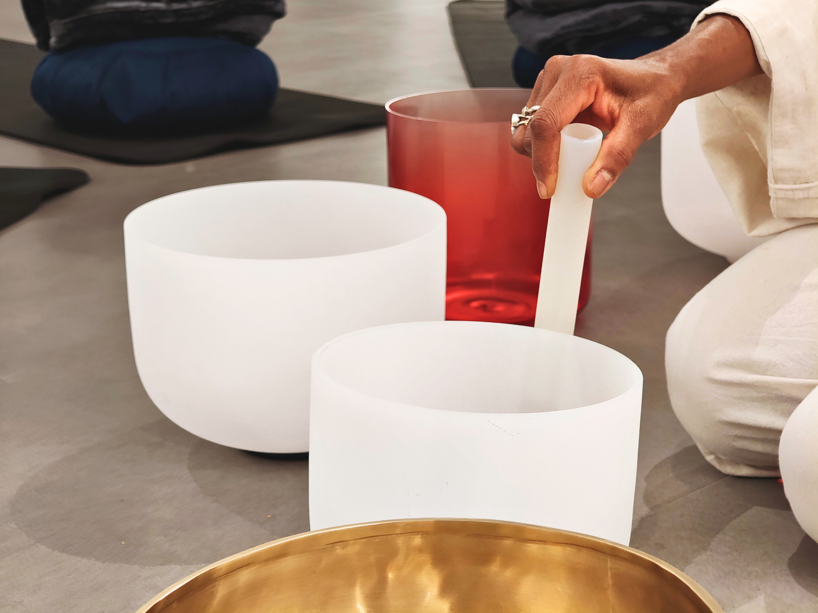 Crystal singing bowl being played during a Sanctue session