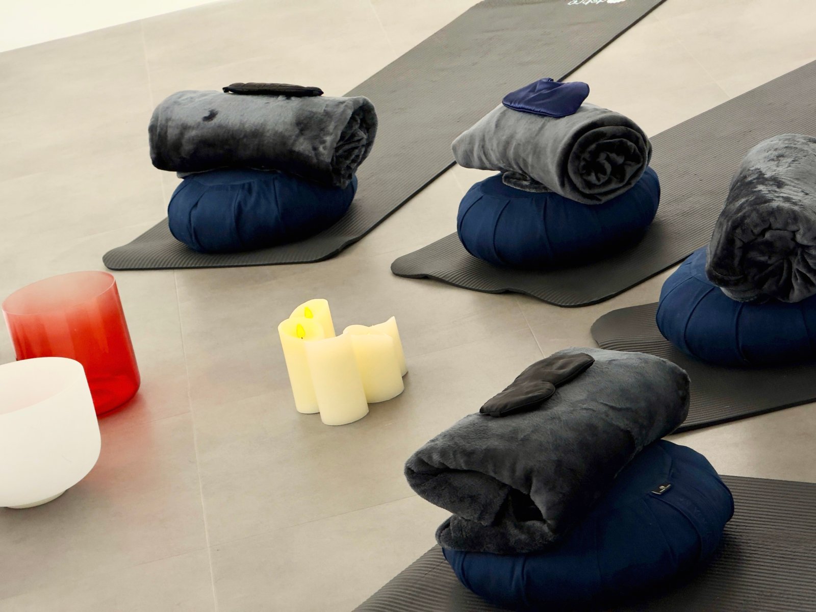 Sanctue sound-bath relaxation setup with mats and blankets